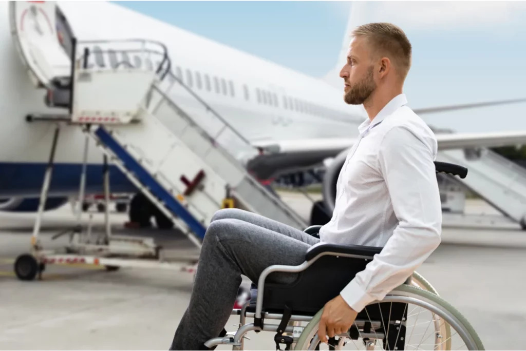Personne en fauteuil roulant près d'un avion